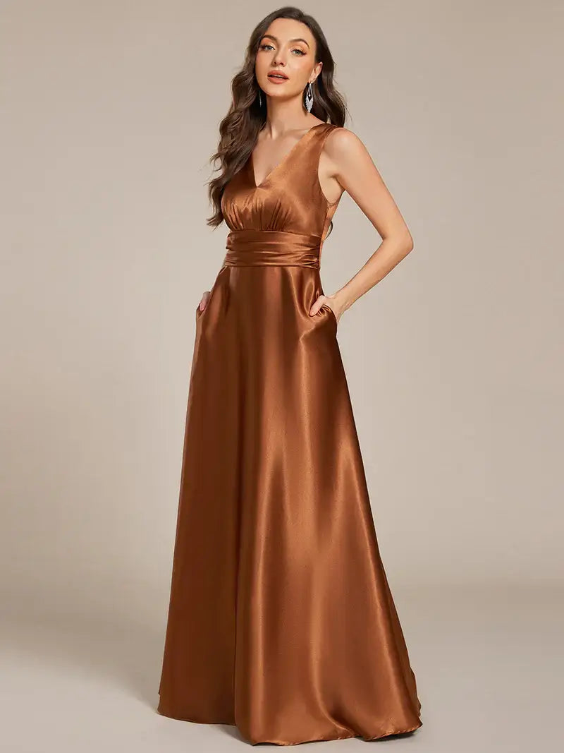 Woman wearing a Copper evening gown against a beige background